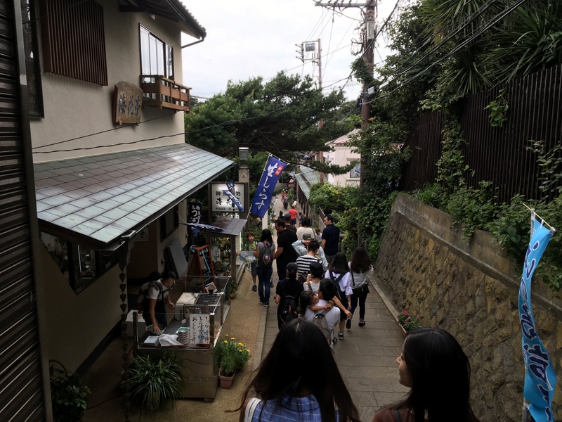 The island's pathways are lined with traditional shops and restaurants. Take a break before continuing to the shrines.