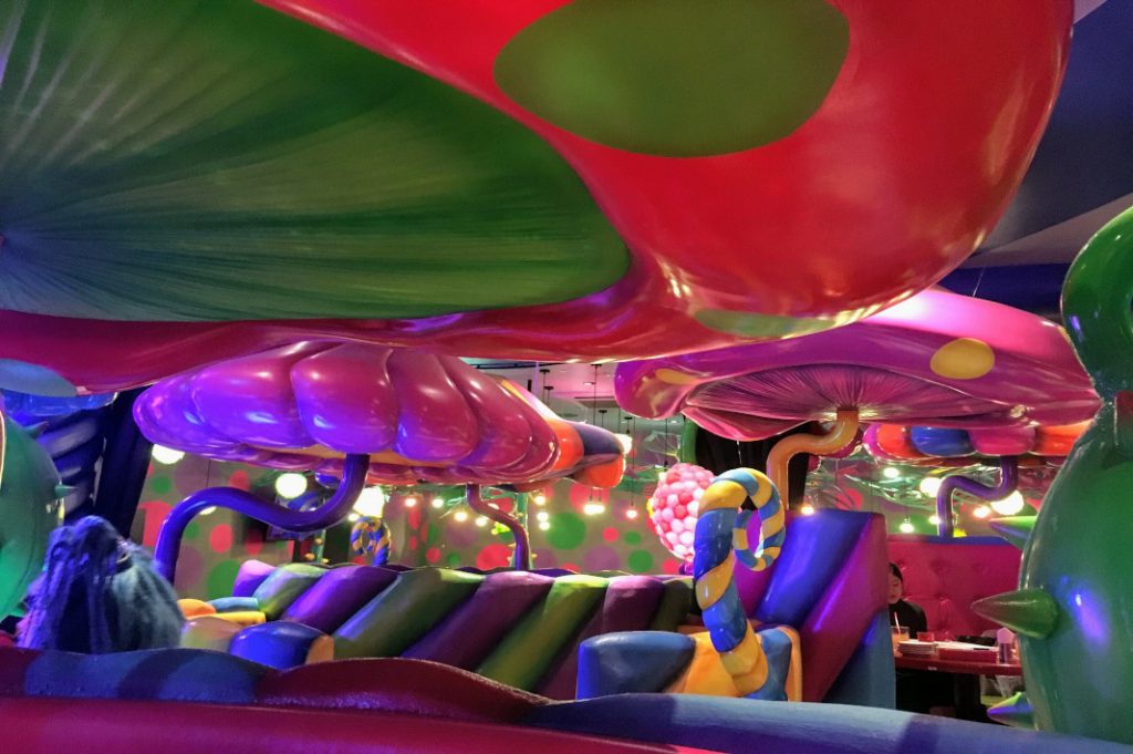 Vibrant mushrooms shade the cafe's booths inside Kawaii Monster café.