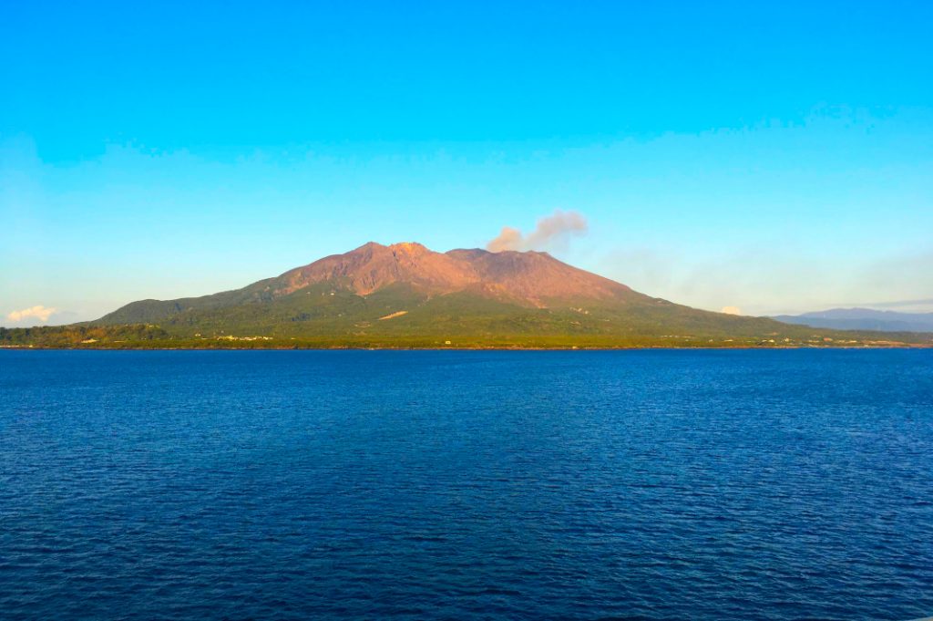 The small puff of smoke rising from the top of Sakurajima are actually volcanic ash.