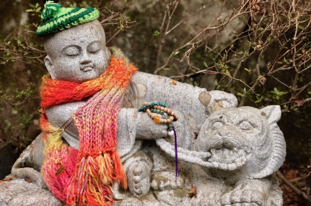 An adorable statue on Miyajima with a hat