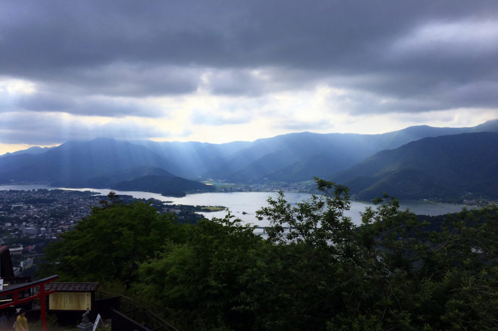 Sun breaks through the clouds over Lake Kawaguchiko—the perfect overnight trip from Tokyo