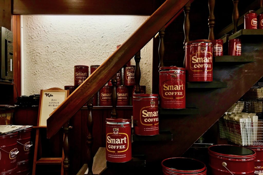 Tins of coffee along the staircase at Smart Coffee Kyoto
