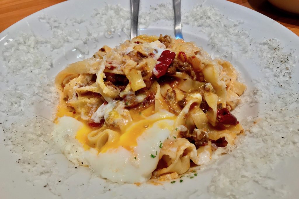 adding egg to the pasta at the yoyogi restaurant