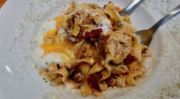 Superb Slurps at street pasta company adding an egg to your pasta