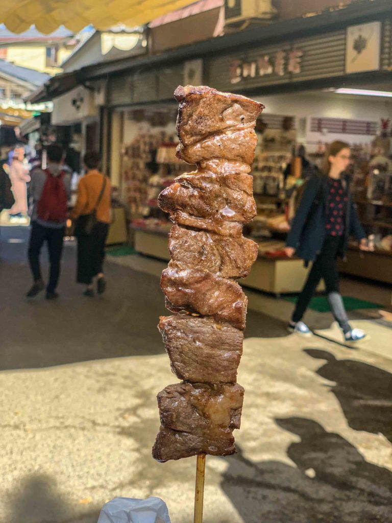 Enjoying a wagyu skewer in the omotesando shopping street