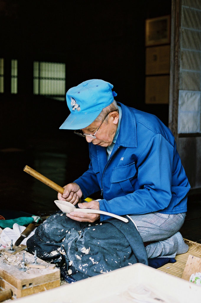 Master craftsmen are deeply absorbed in their traditional work.