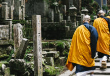 Okuno-in: Kōyasan’s Pathway Through Time A banner image of Buddhist monks climbing steps.