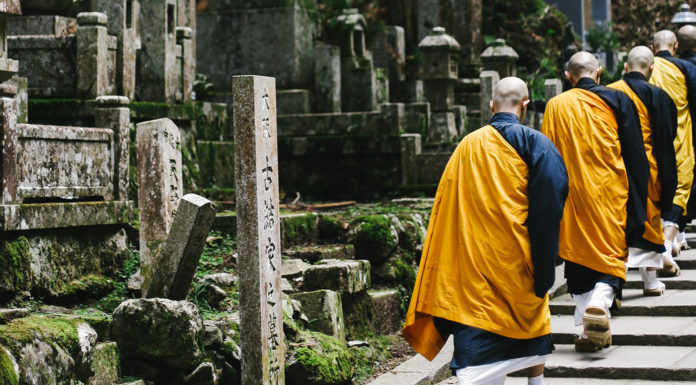Okuno-in: Kōyasan’s Pathway Through Time A banner image of Buddhist monks climbing steps.