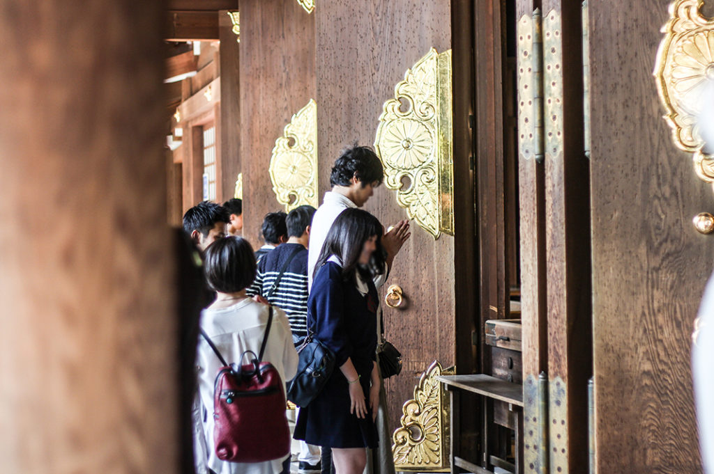 Praying at Meiji Shrine in Tokyo