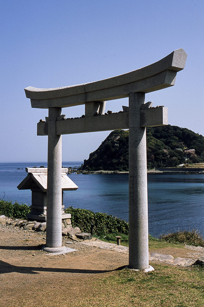 Oshima's coast is a mix of rocky cliffs and safe bays, dotted with small shrines and rickety houses. Munakata Taisha sits behind this torii gate.