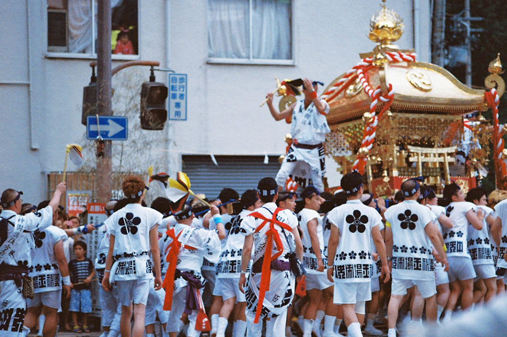 Local men bear the huge weight of one of Tenjin's many Mikoshi (portable shrines).