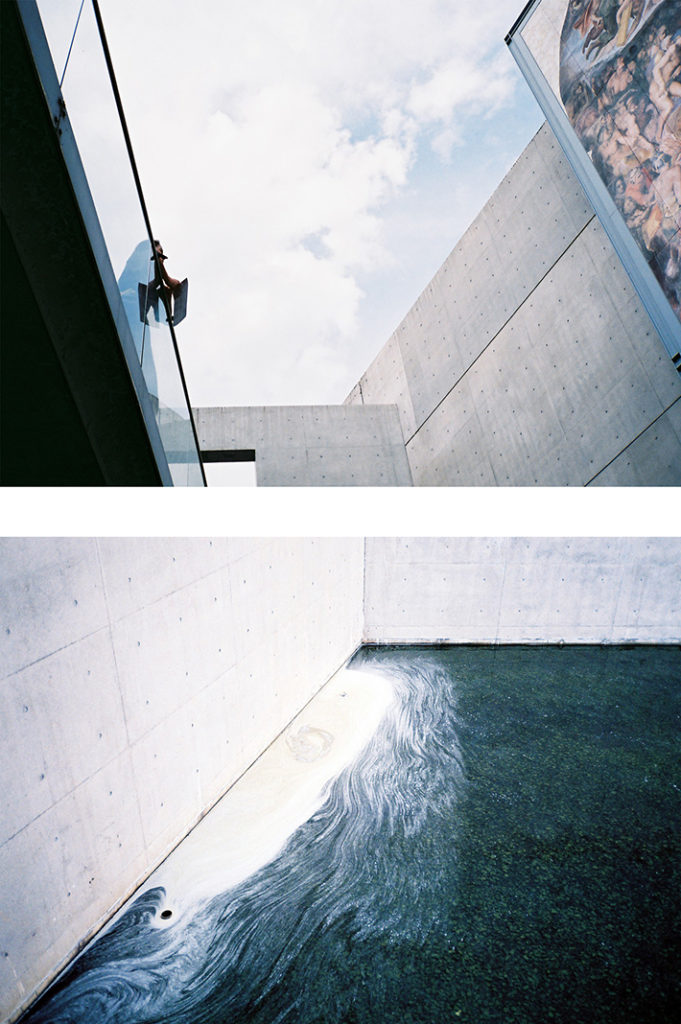 A visitor gazes across an open space at The Last Judgement. Below, pond scum swirls white against a teal pond. Tags: architecture, design, Tadao Ando, The Garden of Fine Arts.