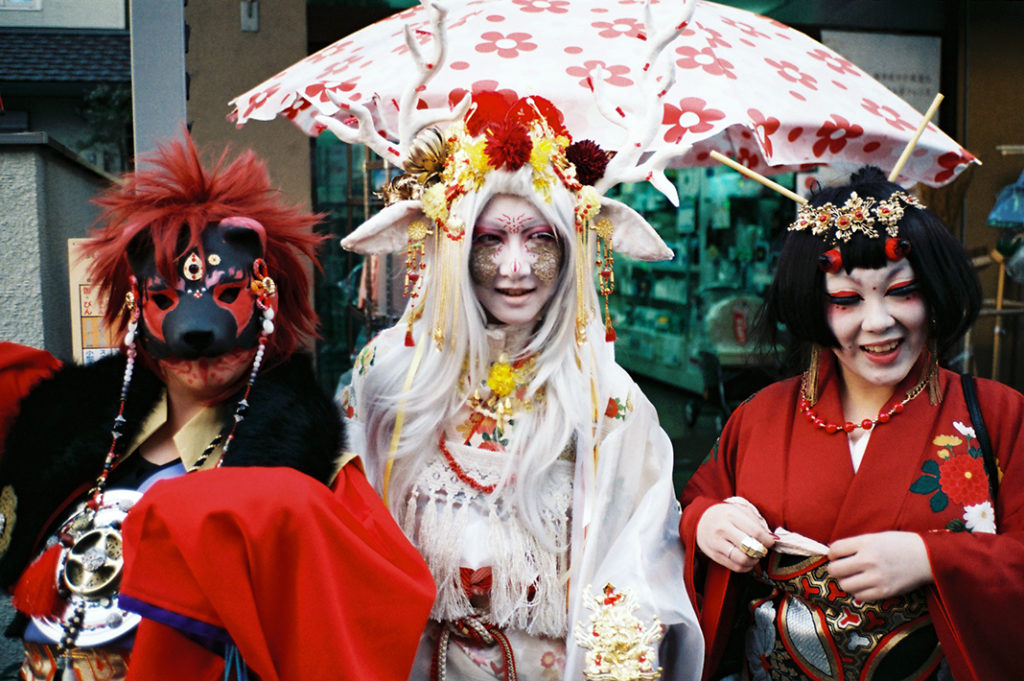 A group of young women in red and white Yokai costumes. Tags: cosplay, ghosts, ghouls