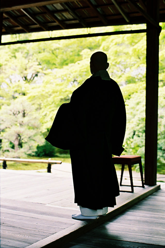 A senior monk from nearby Nanzen-ji takes a stroll around Tenju-an gardens. 
