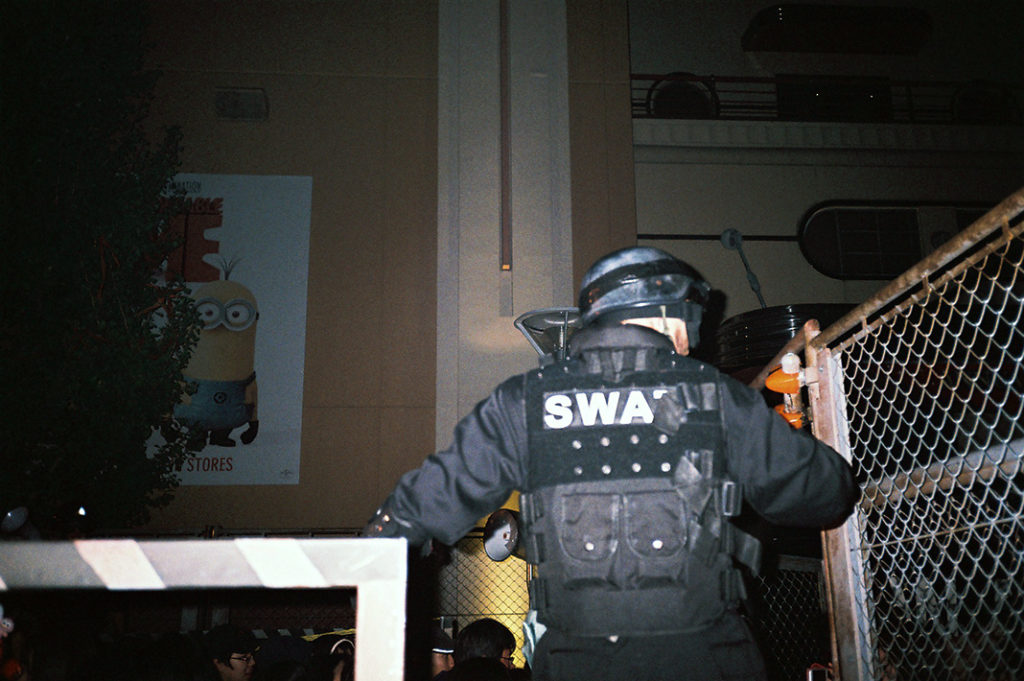 A SWAT officer controls crowds at a Halloween event in Osaka, Japan. 2 points!