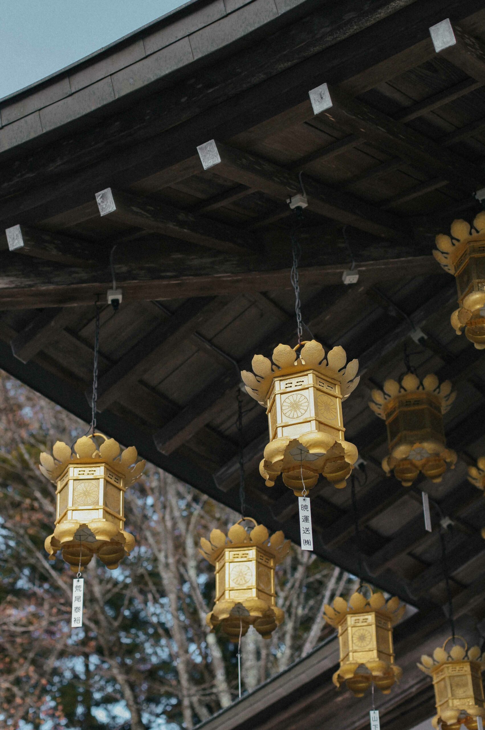 Shining golden lanterns hang from the temple's eaves.