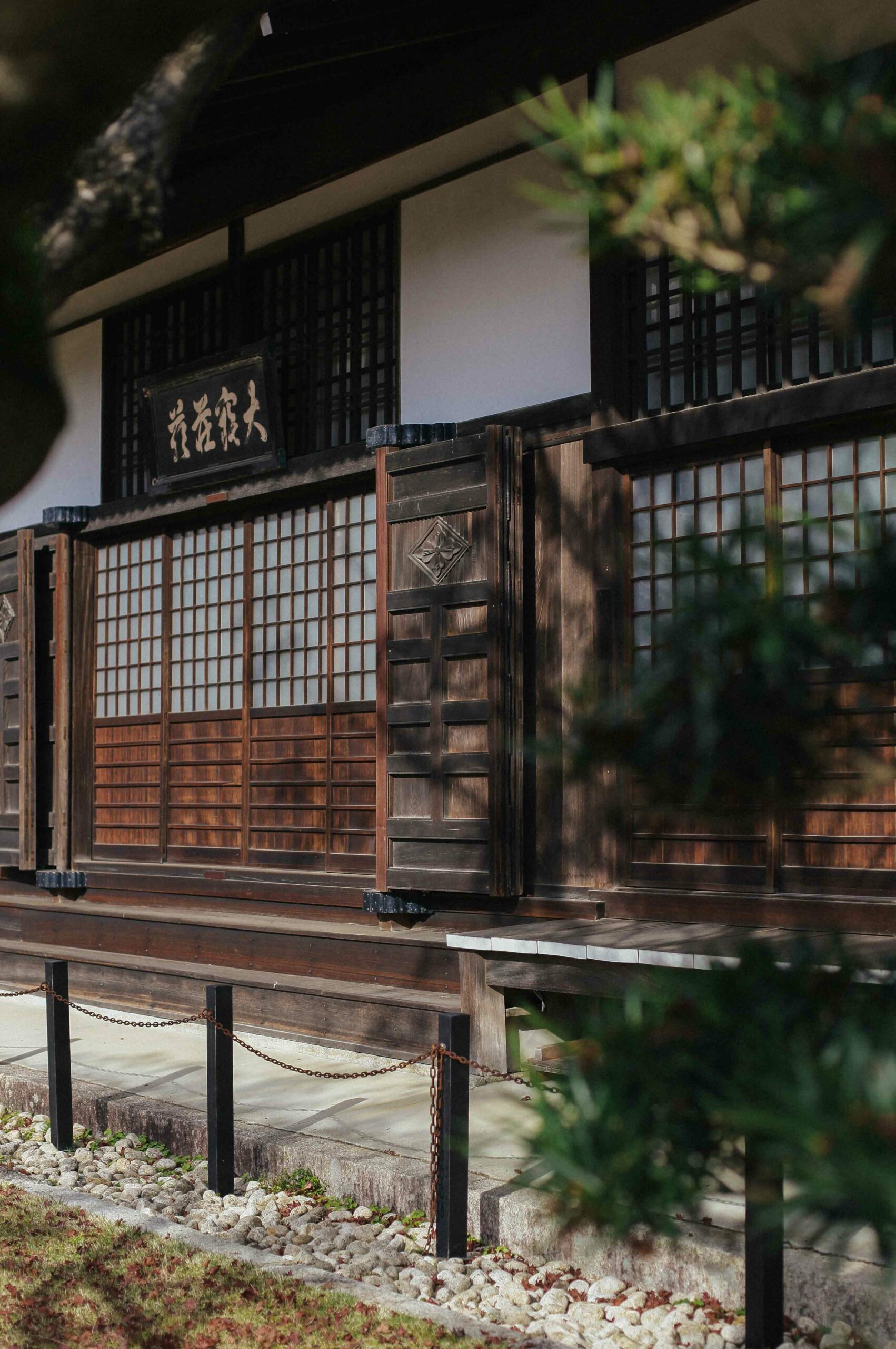 The temple is clad in warm-hued wood and shoji screens.