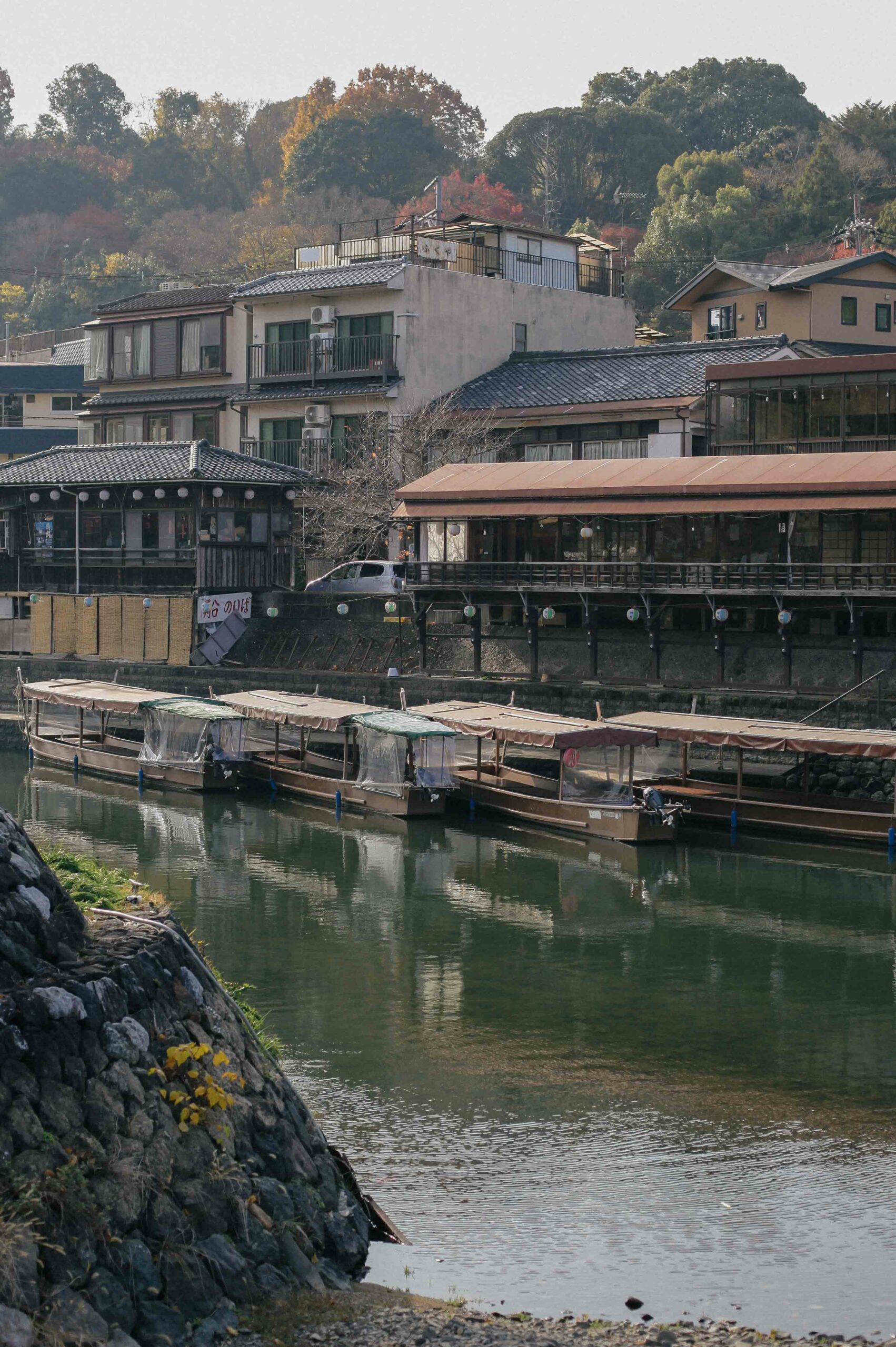 A hazy morning overlooking tourist boats on the river.