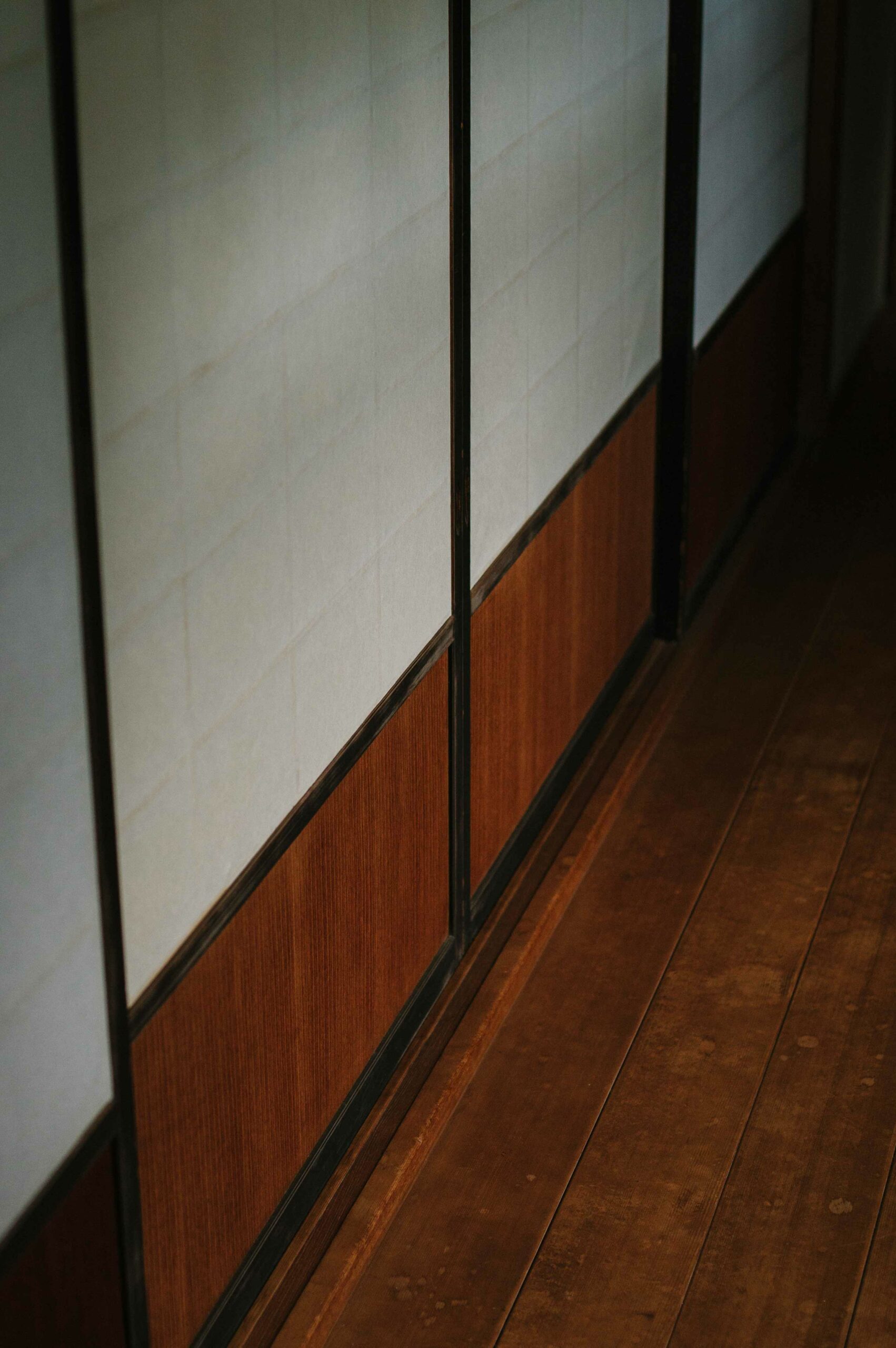 Traditional shoji screens and wooden engawa create a historical atmosphere within the house.