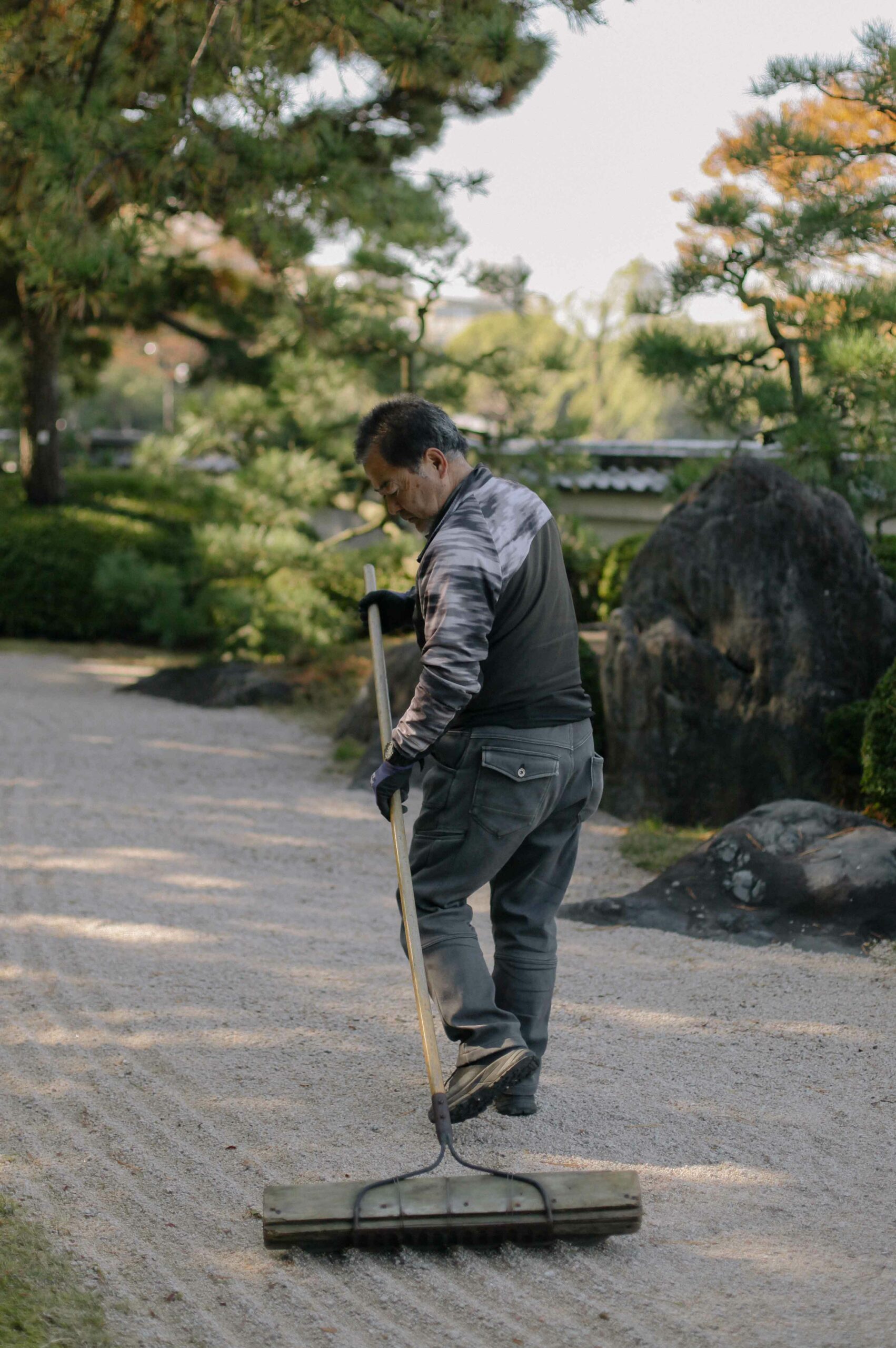 The practice of raking gravel at Ōhori Park Japanese Garden may not be a Zen one, but it looks relaxing.
